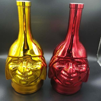 Electroplated gold red face shape glass bottle